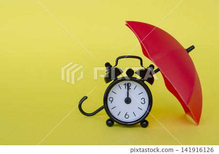 Red umbrella covering an alarm clock symbolizing time protection, insurance planning and financial security Red umbrella covering an alarm clock symbolizing time protection, insurance planning and financial security 141916126