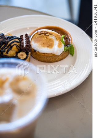 Caramel tart with toasted meringue and chocolate dessert Caramel tart with toasted meringue and chocolate dessert 141916341