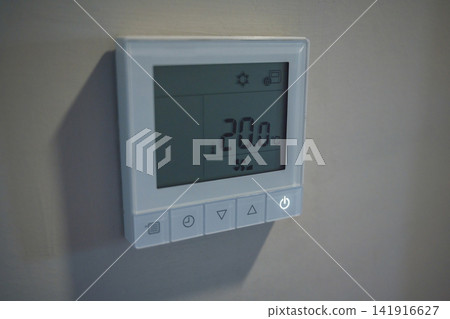 Digital air conditioning thermostat showing 20 degrees, cooling temperature control and energy saving concept Digital air conditioning thermostat showing 20 degrees, cooling temperature control and energy saving concept 141916627
