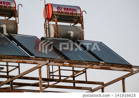 Manavgat, Antalya Province, Turkey, July 26, 2026: Rooftop solar water heating systems on a residential building Manavgat, Antalya Province, Turkey, July 26, 2026: Rooftop solar water heating systems on a residential building 141916628