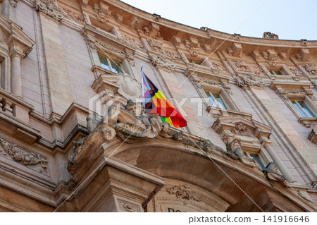 Palazzo Marino Facade Detail with Stone Statues and Rainbow Flag Piazza della Scala Milan Italy Palazzo Marino Facade Detail with Stone Statues and Rainbow Flag Piazza della Scala Milan Italy 141916646