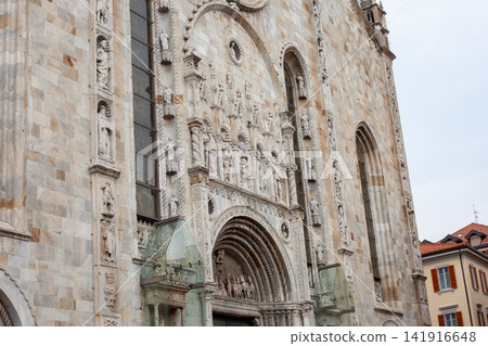 Old Church in Italy Como Cathedral Duomo Italian old temple in center. Santa Maria Assunta square. Como city center house building architecture. Street wall facade Old Church in Italy Como Cathedral Duomo Italian old temple in center. Santa Maria Assunta square. Como city center house building architecture. Street wall facade 141916648
