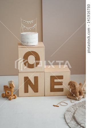 Wooden ONE letter cubes with cake stand and toys for first birthday photo shoot Wooden ONE letter cubes with cake stand and toys for first birthday photo shoot 141916780