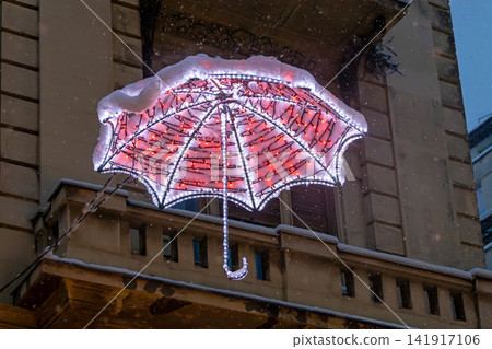 Dlowing winter umbrella on street Dlowing winter umbrella on street 141917106