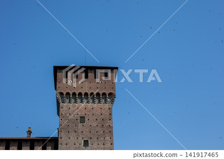 Tower of Sforza Castle Brick Facade against Blue Sky in Milan City Center Italy Tower of Sforza Castle Brick Facade against Blue Sky in Milan City Center Italy 141917465