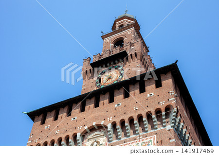 Filarete Tower Clock of Sforza Castle Brick Facade against Blue Sky in Milan City Center Italy 141917469