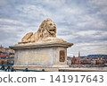 Majestic Lion Statue on Pedestal with Inscription Budapest Landmark 141917643