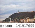 Budapest Liberty Statue on Gellert Hill with Flag and Chain Bridge 141917655