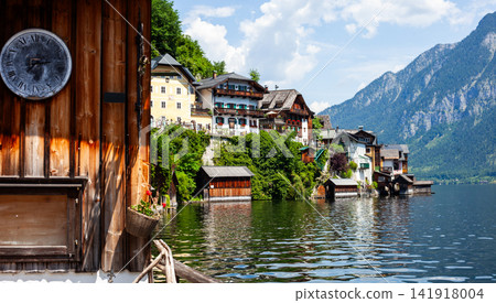 Hallstatt Lake, with Wooden Clock, Houses, and Mountains in Austria Hallstatt Lake, with Wooden Clock, Houses, and Mountains in Austria 141918004