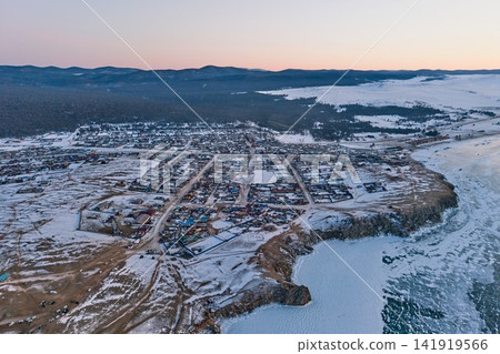 The village of Fujil and Lake Baikal spread out against the snowy landscape at dusk. The village of Fujil and Lake Baikal spread out against the snowy landscape at dusk. 141919566