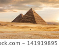 Mysterious pyramids in Giza desert under sunset sky in Egypt 141919895
