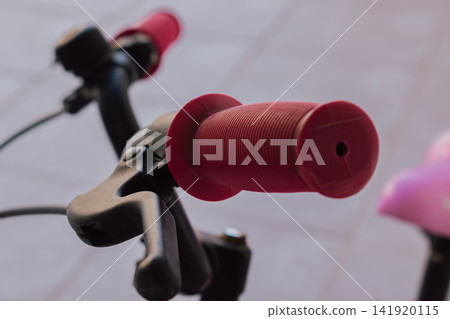 Close up view of pink rubber handlebars grip and brake lever on kids bicycle concept of old rusty neglected children bike needing repair and maintenance photo Close up view of pink rubber handlebars grip and brake lever on kids bicycle concept of old rusty neglected children bike needing repair and maintenance photo 141920115