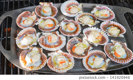 Fresh scallops grilled on cast iron skillet over barbecue Fresh scallops grilled on cast iron skillet over barbecue 141920948