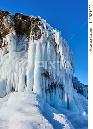 Icicles and ice formations covering the rocky cliffs of Lake Baikal Icicles and ice formations covering the rocky cliffs of Lake Baikal 141921021