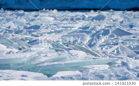 Blue-green ice floes shimmering in the sunlight, Lake Baikal in winter. 141921030