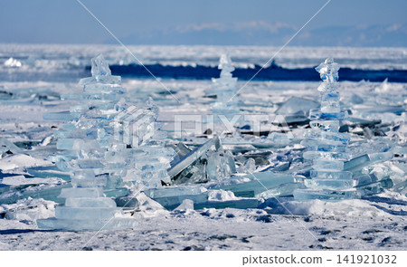 A stack of transparent ice sheets stands on the frozen Lake Baikal. A stack of transparent ice sheets stands on the frozen Lake Baikal. 141921032