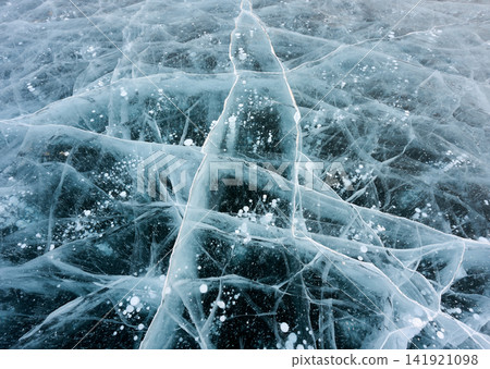 Air bubbles floating on cracked, transparent ice, Lake Baikal in winter. Air bubbles floating on cracked, transparent ice, Lake Baikal in winter. 141921098