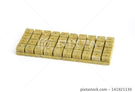 A sheet of precut square rockwool cubes on a white background, ready for hydroponic planting and propagation. A sheet of precut square rockwool cubes on a white background, ready for hydroponic planting and propagation. 141921130