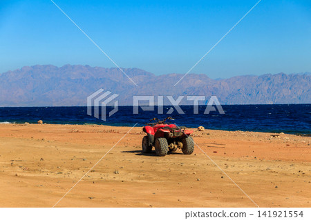 ATV quad bike for safari trips on a shore of the Red Sea in the Gulf of Aqaba. Dahab, Egypt ATV quad bike for safari trips on a shore of the Red Sea in the Gulf of Aqaba. Dahab, Egypt 141921554