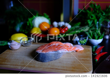Step by step salmon recipe asparagus garlic butter cooked on stainless steel skillet in modern kitchen healthy gourmet meal preparation salmon recipe, healthy, cooking process, restaurant style meal 141921606