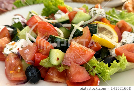 greek style salad with feta tomatoes cucumbers onions and lemon slice fresh food greek style salad with feta tomatoes cucumbers onions and lemon slice fresh food 141921608