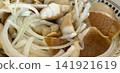 white mushrooms with onions in spotted plate on rustic table food scene  141921619