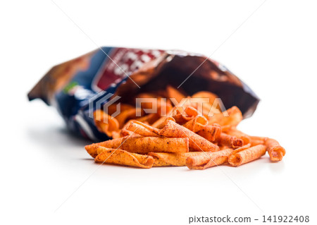 Spicy Rolled Corn Snacks Piled in an Open Bag on White Background Spicy Rolled Corn Snacks Piled in an Open Bag on White Background 141922408