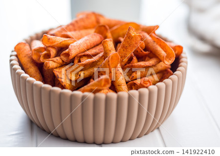 Spicy Rolled Corn Chips in Ceramic Bowl Close-Up Crispy Snack for Parties Spicy Rolled Corn Chips in Ceramic Bowl Close-Up Crispy Snack for Parties 141922410