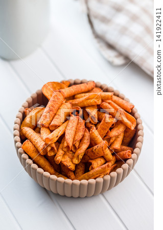 Spicy Rolled Corn Chips in Ceramic Bowl Close-Up Crispy Snack for Parties Spicy Rolled Corn Chips in Ceramic Bowl Close-Up Crispy Snack for Parties 141922411