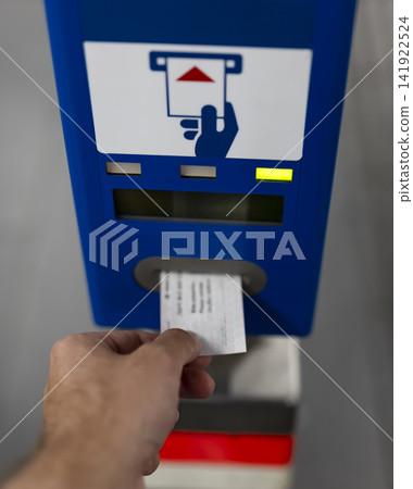 Person validating a ticket at a Vienna subway station machine, illustrating public transport infrastructure and user experience. Person validating a ticket at a Vienna subway station machine, illustrating public transport infrastructure and user experience. 141922524