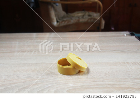 Plastic Box for Anti-Stress Toy on the Table. Lost Toys. Plastic Box for Anti-Stress Toy on the Table. Lost Toys. 141922783