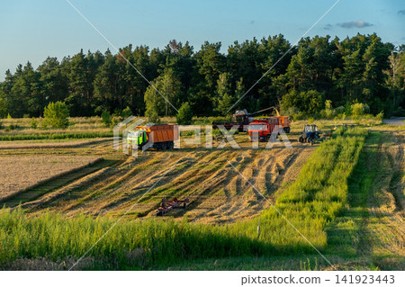 Agricultural machinery including trucks, a tractor, and a combine harvester Agricultural machinery including trucks, a tractor, and a combine harvester 141923443