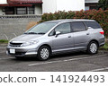A passenger car parked in a parking lot 141924493