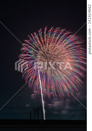 A magnificent, seven-colored fireworks display blooms in the night sky. A magnificent, seven-colored fireworks display blooms in the night sky. 141924662