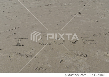 The words "I LOVE" written in the sand. The words "I LOVE" written in the sand. 141924809