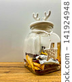 Glass Jar with Antler Lid and Christmas Star Pendant Filled with Candies 141924948