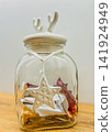 Glass Jar with Antler Lid and Christmas Star Pendant Filled with Candies 141924949