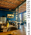 Modern Loft Restaurant Interior with Brick Vaulted Ceiling and Blue Wall 141925076