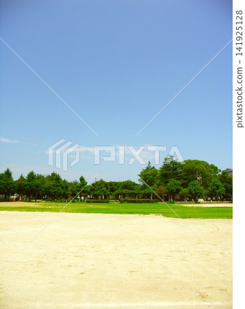 A scene of a deserted baseball field next to a park on a scorching hot summer day. A scene of a deserted baseball field next to a park on a scorching hot summer day. 141925128