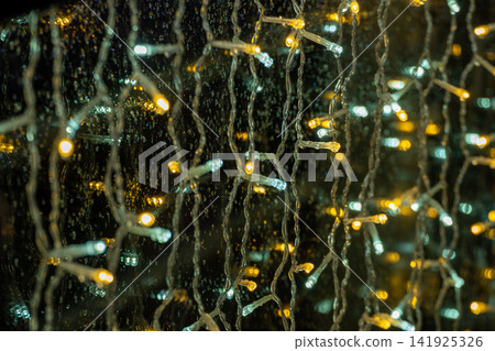 Illumination lights and bokeh seen through a window on a rainy night Illumination lights and bokeh seen through a window on a rainy night 141925326