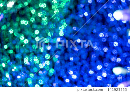 A fantastical bokeh background shimmering with blue and green light. 141925333