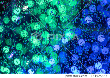 An abstract background with water droplets and blurred blue and green light. An abstract background with water droplets and blurred blue and green light. 141925334