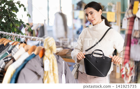 Armenian woman chooses a fashionable handbag Armenian woman chooses a fashionable handbag 141925735