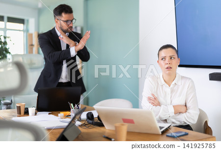man, the head of a successful company, chastises an employee from the IT man, the head of a successful company, chastises an employee from the IT 141925785
