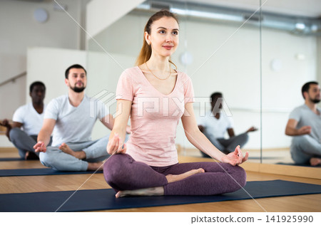 People exercising lotus asana in gym 141925990