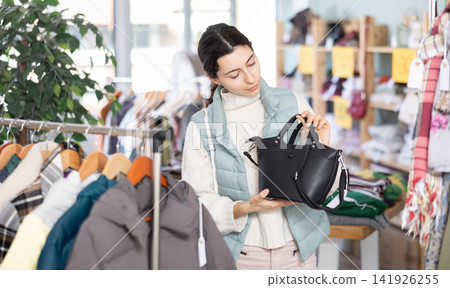 Armenian woman chooses a fashionable handbag Armenian woman chooses a fashionable handbag 141926255