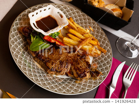 fried veal with French fries and spicy sauce fried veal with French fries and spicy sauce 141926428