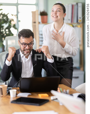 Man and girl office employees is genuinely happy and elated 141926456