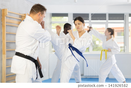 Adult man and young woman training judo techniques 141926582