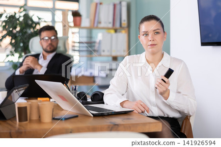 Male and female colleagues are watching presentation in office Male and female colleagues are watching presentation in office 141926594